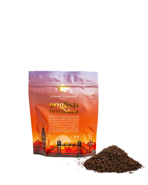 English Breakfast pouch beside a scattering of loose black tea